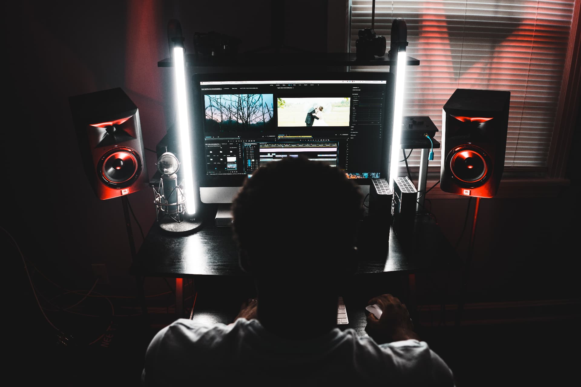 Editor working on a video timeline in a dark studio