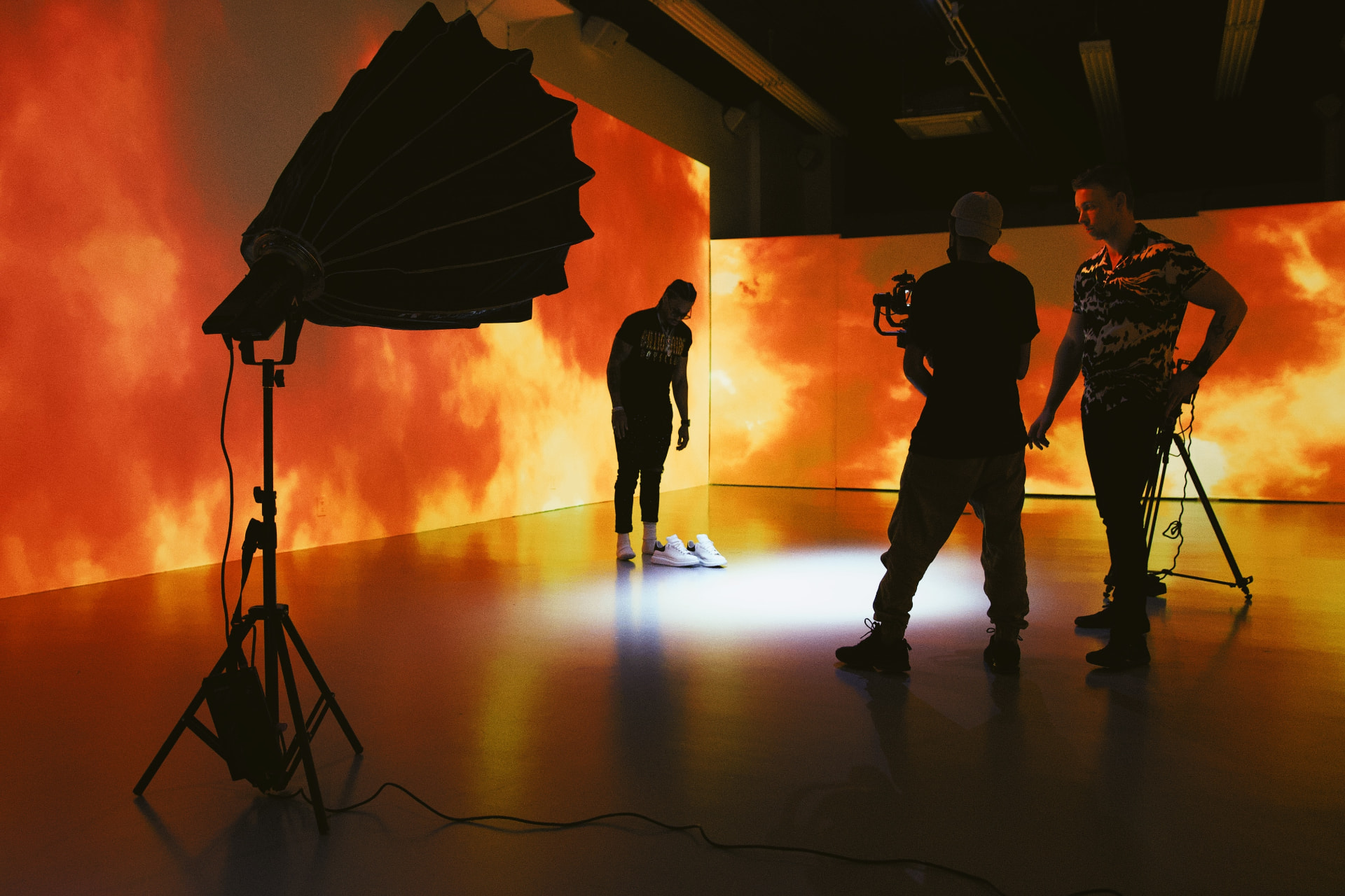 Production crew filming on a lit studio set